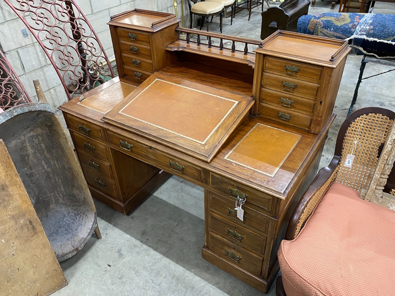 A late Victorian mahogany pedestal desk with hinged slant front, width 137cm, depth 73cm, height 113cm